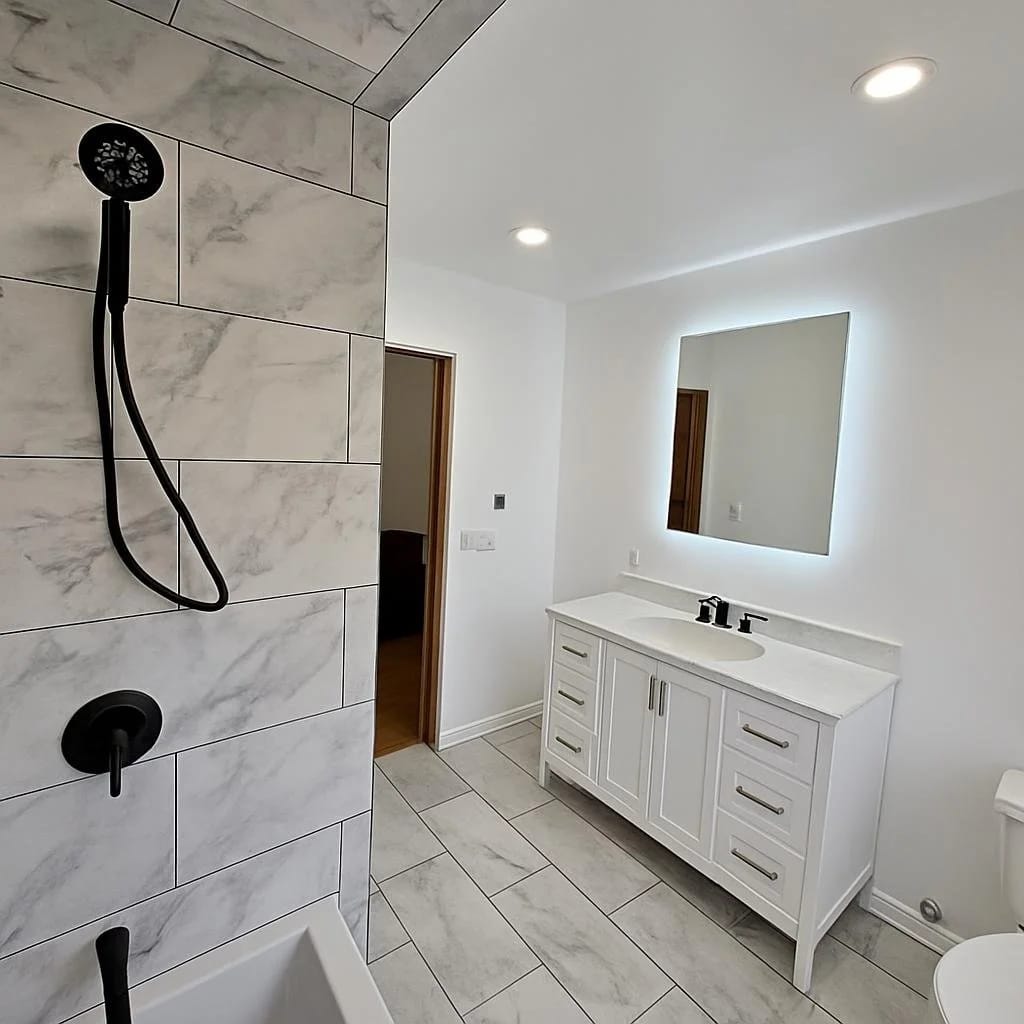 Bright bathroom with a custom white double-sink vanity and large mirrors